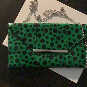 Green and black polka dot patent leather clutch